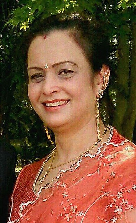 A close up of Indian woman in a peach coloured sari