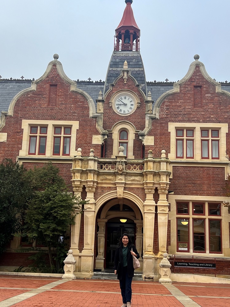 Lordna standing in front of the historic building at Lincoln University