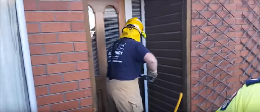 Firefighter at door of property