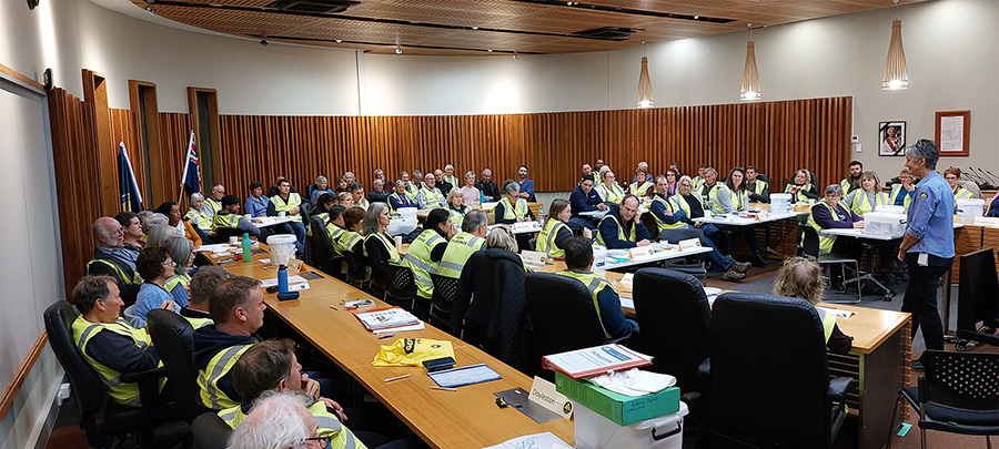 volunteers sit and gather in a room