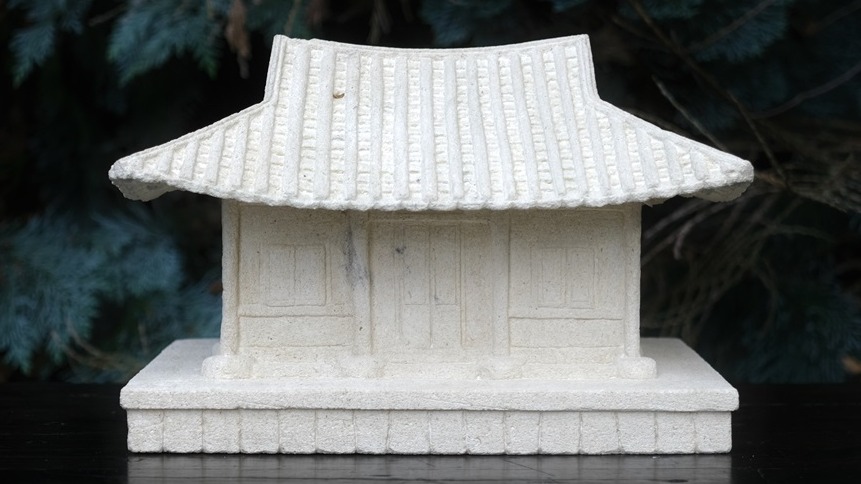 A white sculpture of a traditional Korean house 