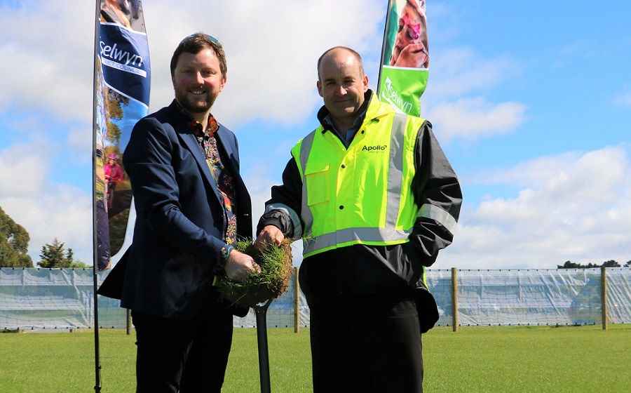 Mayor Sam Broughton and Appollo Projects CEO Paul Lloyd wearing an Apollo branded high visibility vest hold up a sod of earth