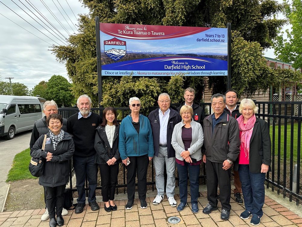 A group of people in front of Darfield High School Sign
