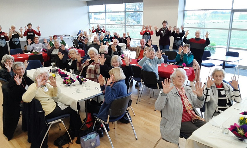 The members of the Springs Day Club at their birthday celebration, all holding up 10 fingers