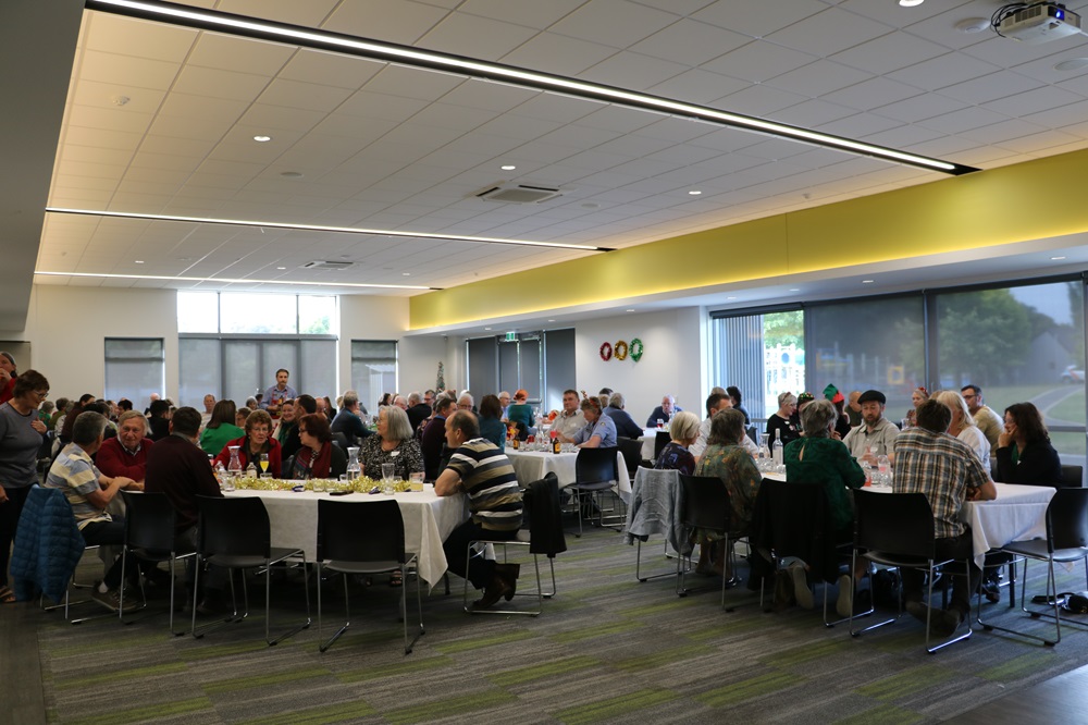 People at tables celebrating and eating
