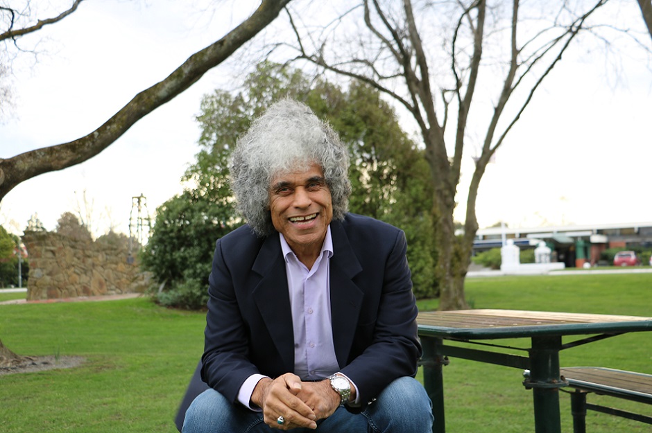 Paul Ubana Jones sitting at a picnic table in a park