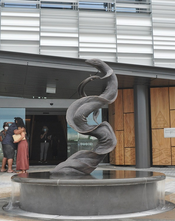 a sculpture of two eels in front of Te Ara Ātea 