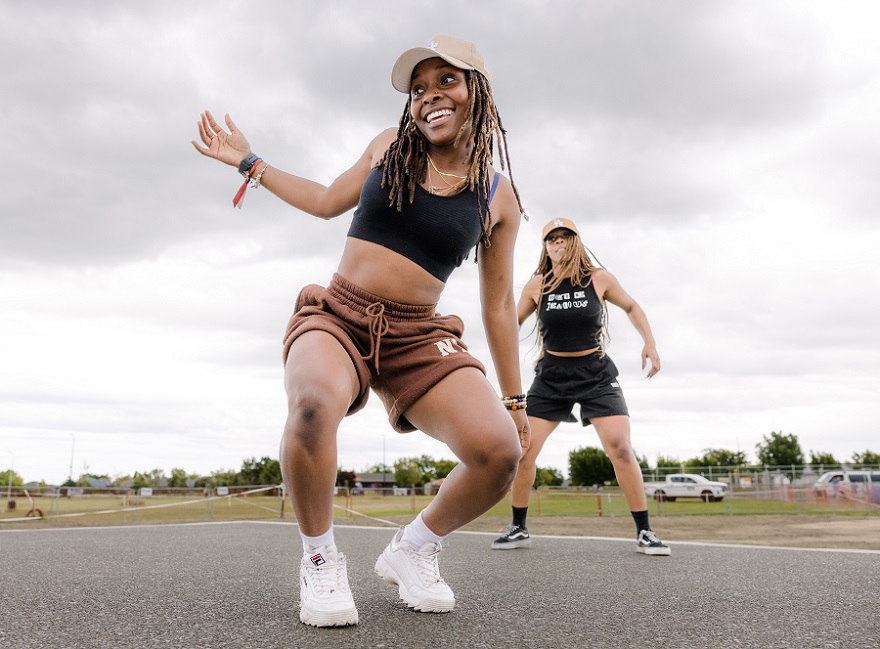 Two young African women performing a hip hop routine