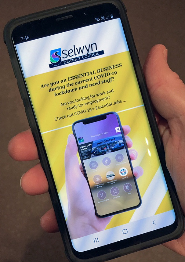 hand holding phone with essential business job connector information on the screen