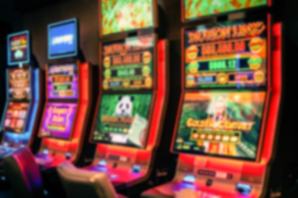 image of four pokie machines lit up in red
