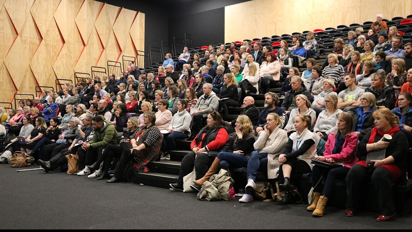 A crowd of over 100 people sitting in the Rolleston College auditorium