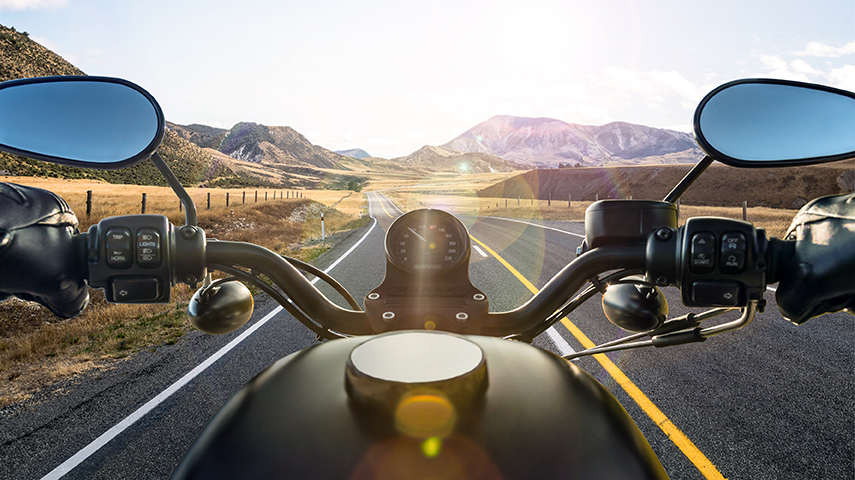 Rural view from motorcycle of mountains and outstretched road