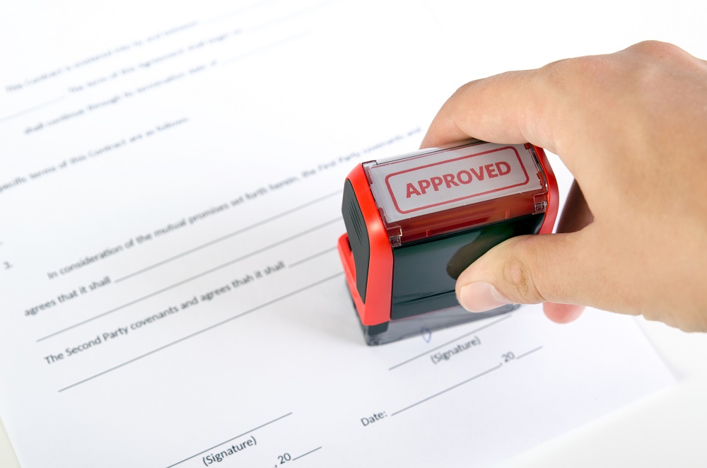 An approved stamp being placed on a form