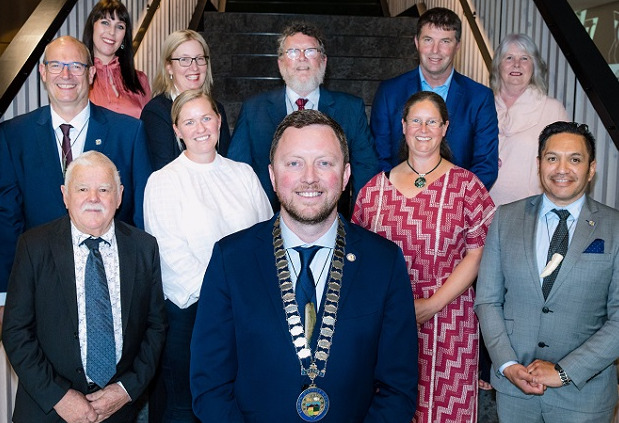 Close up of the new council standing on the stairs at Te Ara Atea with Mayor Sam Broughton front and centre
