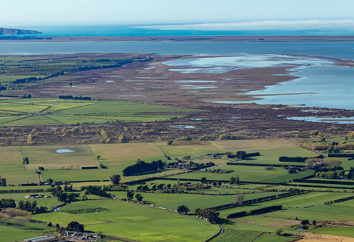 An aerial view of the edge of Lake Ellesmere and the coast