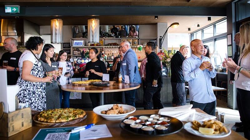 Several business owners networking over food 