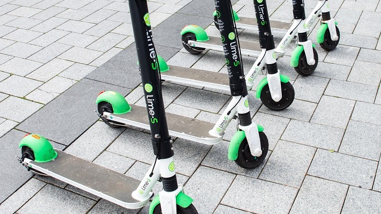 A row of parked Lime Scooters in Christchurch