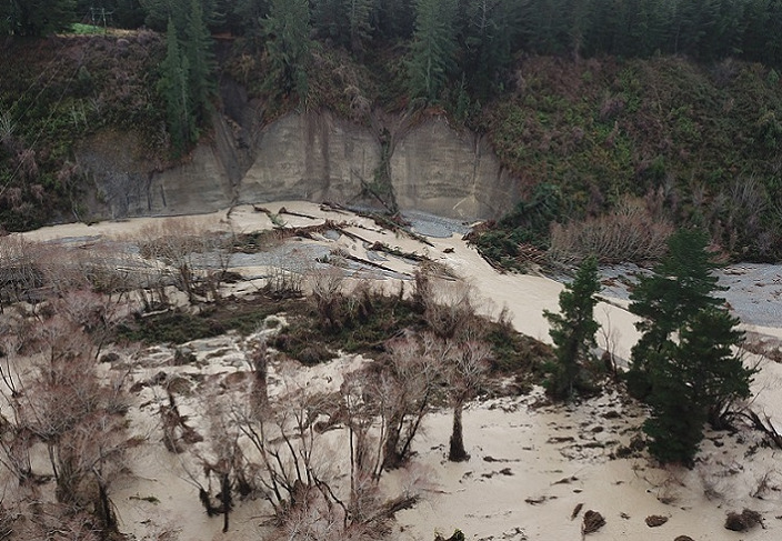 the Kowai River with banks slipped into the river and trees floating in the flood water