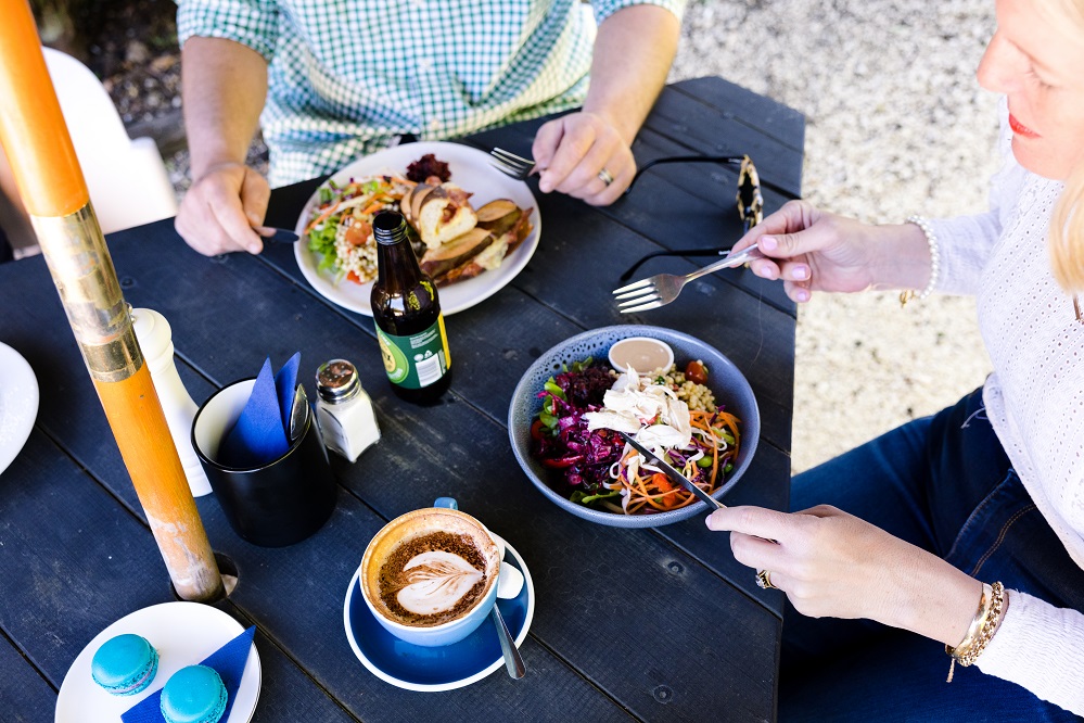 close up aerial view of a woman and man eating at an outdoor table at a restaurant