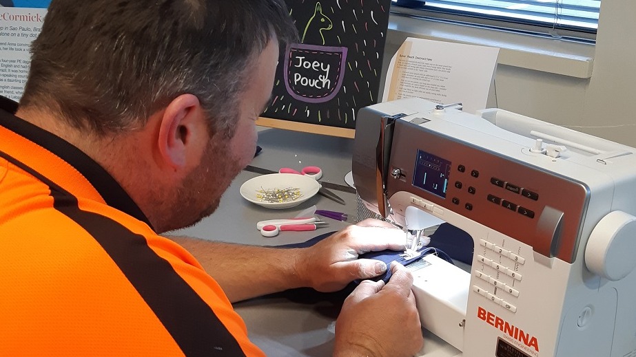 Man on sewing machine