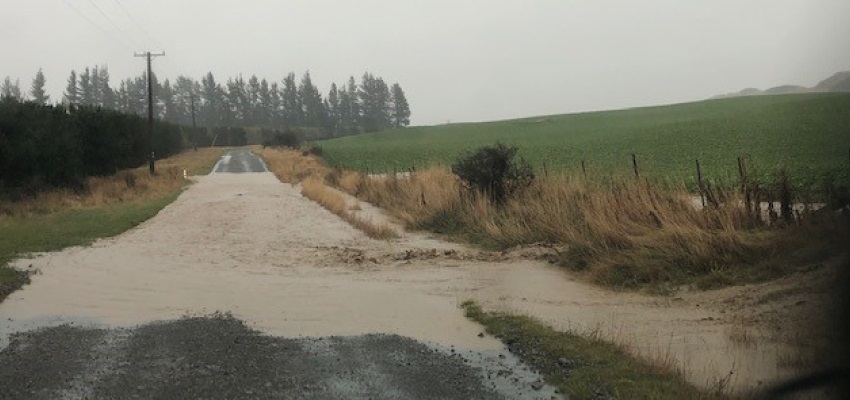A flooded road and field