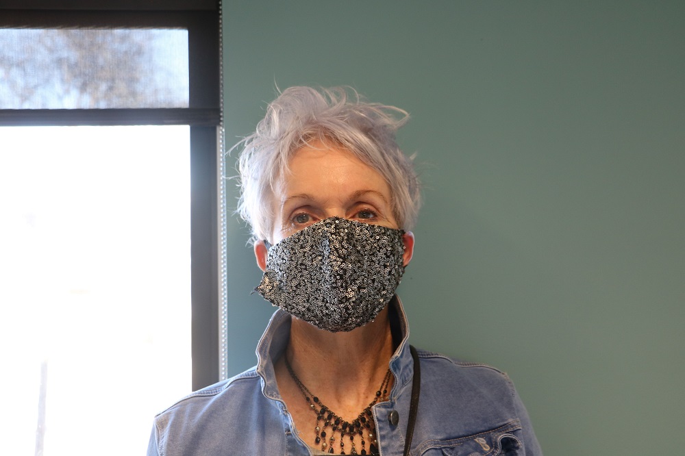Image of a woman in a black mask with silver sequins