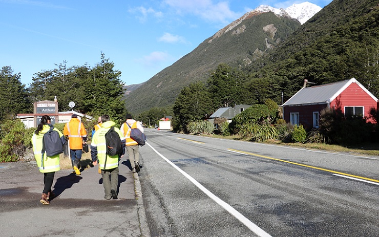 Civil Defence response team in high vis jackets walking through Arthur's Pass Village