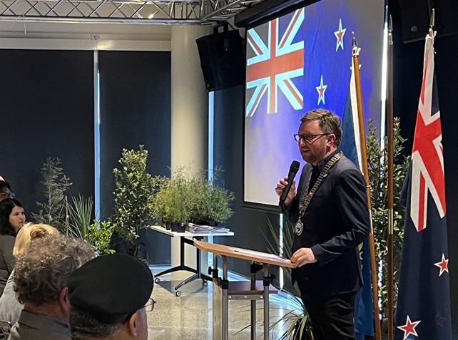 Mayor Sam Broughton speaks on stage at citizenship ceremony