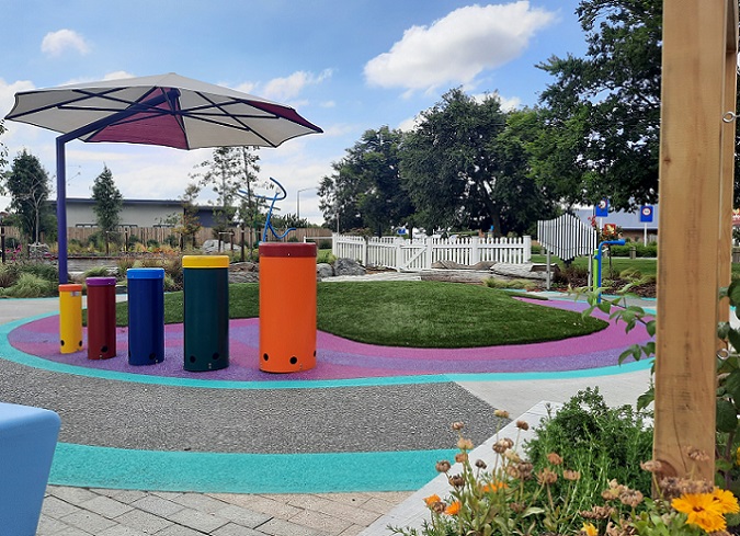 image of gardens in the sensory space, colourful drums and a shade sail