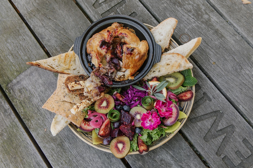 A platter of salad, bread and a baked brie from Memorys Restaurant