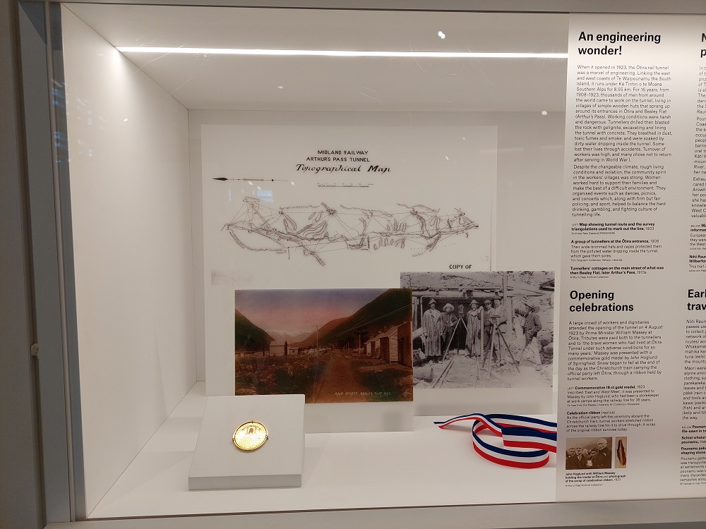 image of a museum display case with a medal and photos in it