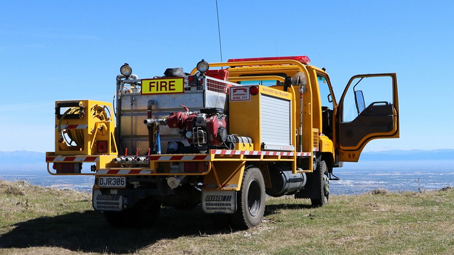 A fire truck sits on the edge of a hill