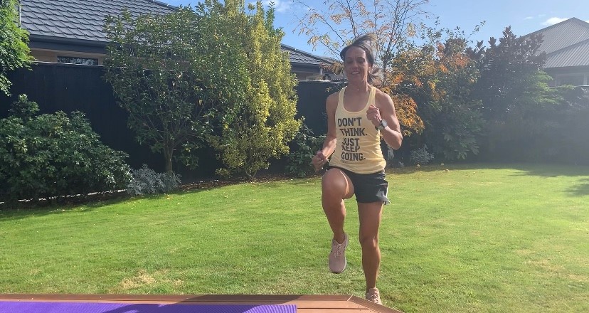 Linda Miratana excersising in a back garden, doing step ups from a lawn onto steps