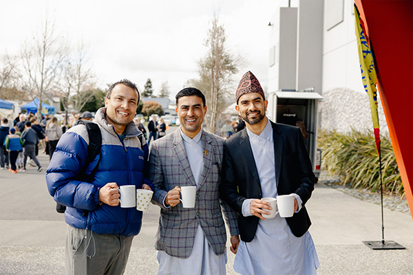 Three men from different ethnicity posing in front of the camera at CultureFest