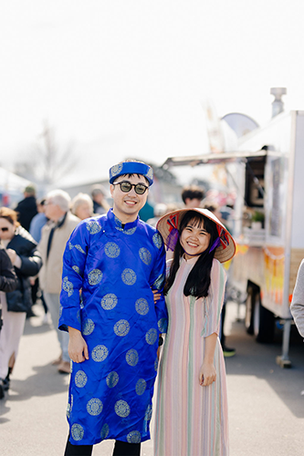Male and female couple from Asian ethnicity pose in front of camera at CultureFest