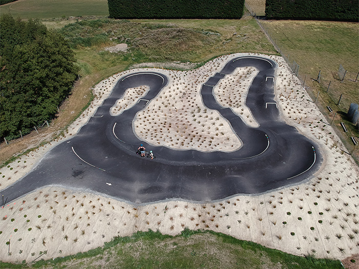 Two people standing at bike park