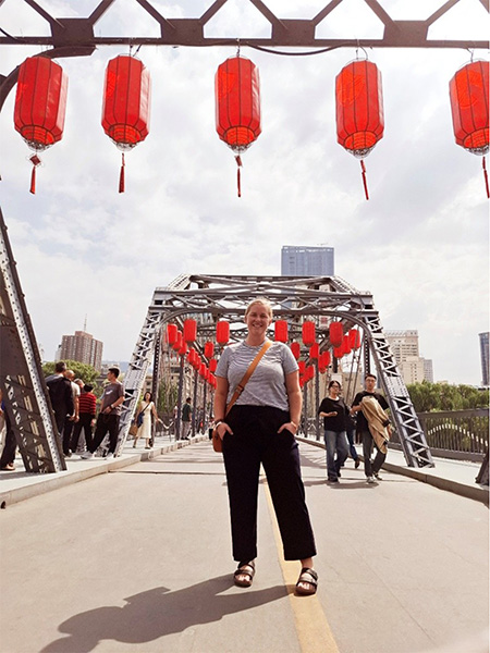 Women stands in front of bridge in China