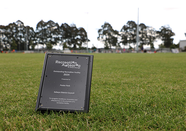 Recreation award plaque sits in the middle of green field 