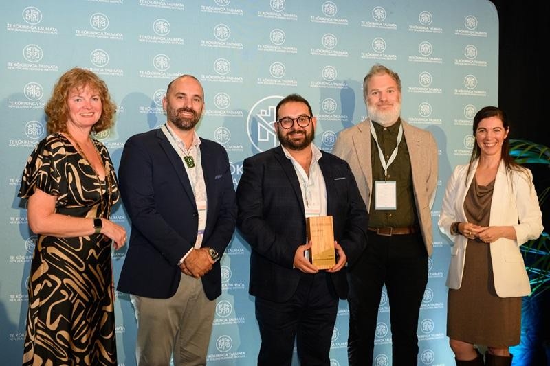 several people stand accepting an award