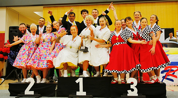 several winners of rock'n'roll champions standing on podium