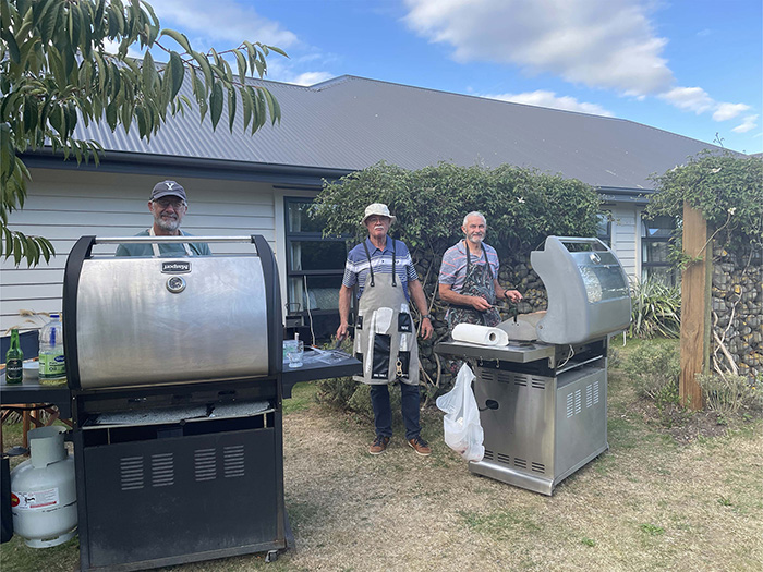 Three men at barbeque