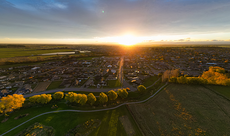 Drone shot showing farmlands, houses, township, waterways, roads and trees