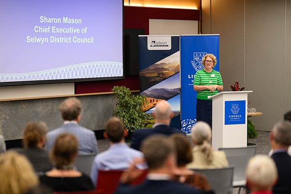 Woman addresses crowd at presentation
