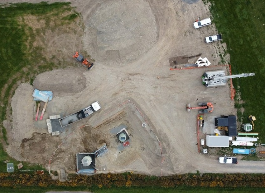 aerial image of the installation of the Kirwee pump station showing cars, trucks and equipment in a cleared space in a field