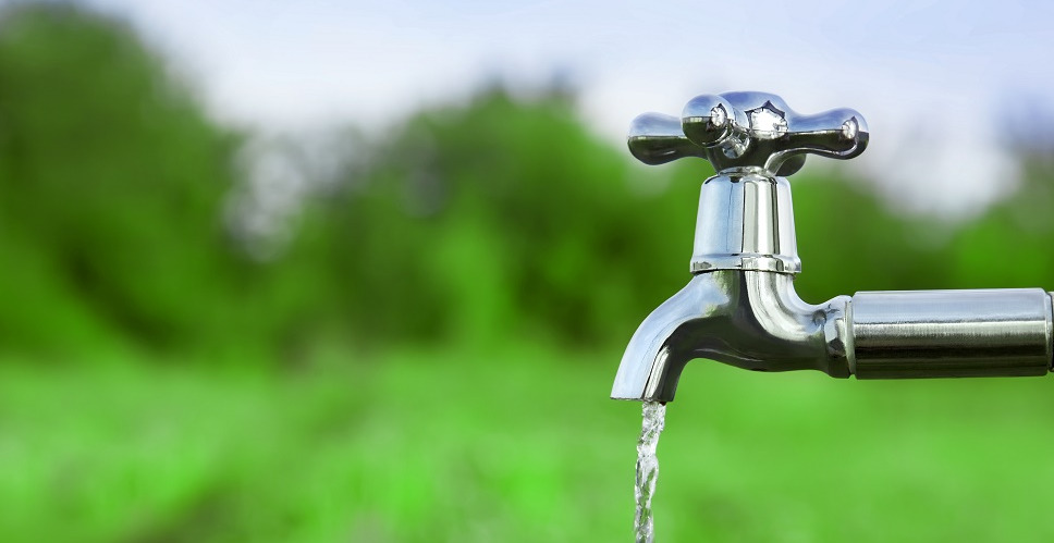 Close up of a tap running outdoors